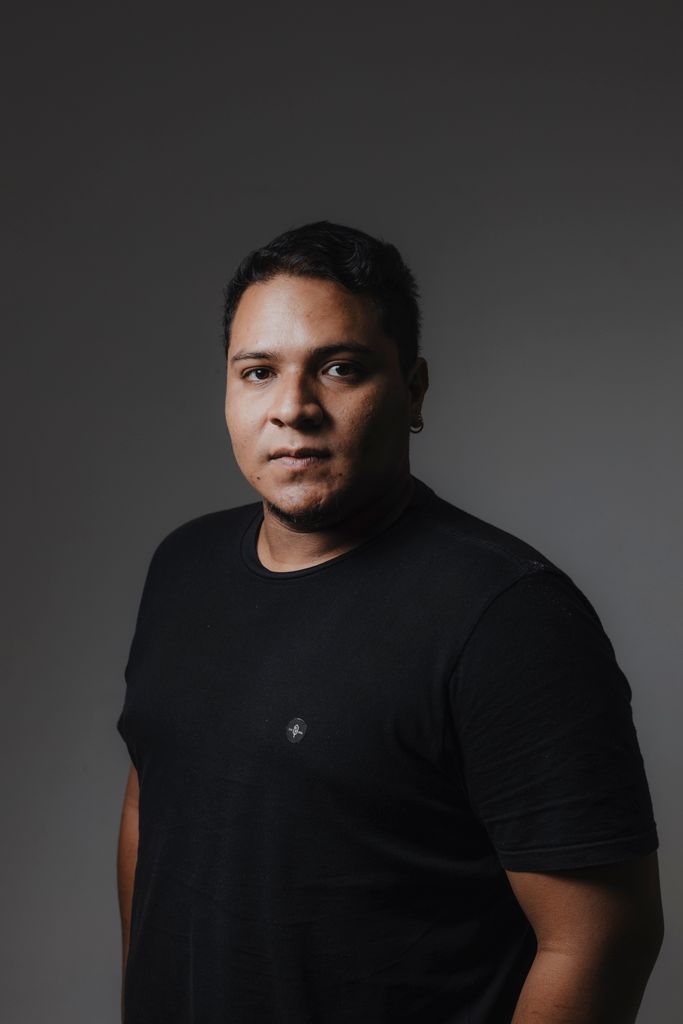 Studio portrait of a man wearing a black T-shirt, neutral background.