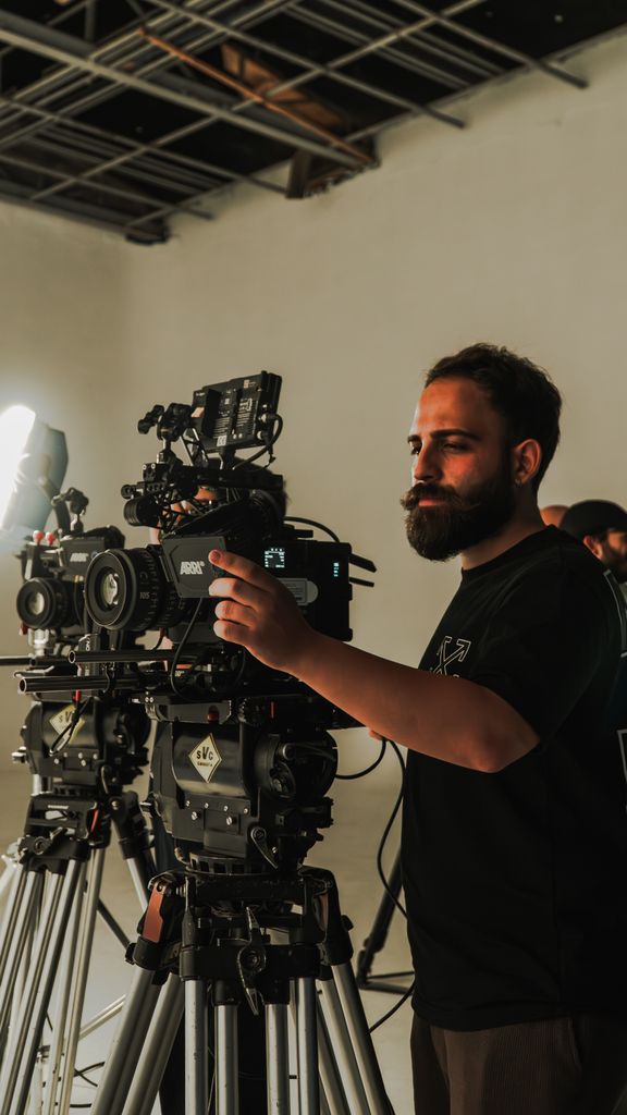 Cinematographer adjusting camera on set in Istanbul studio.
